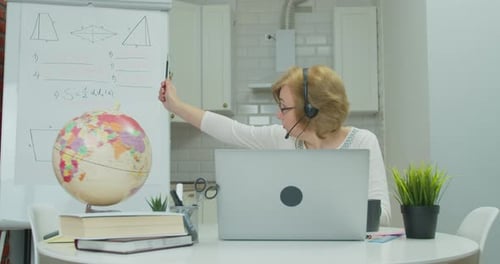 Woman Teaching Online Class With Globe and Whiteboard