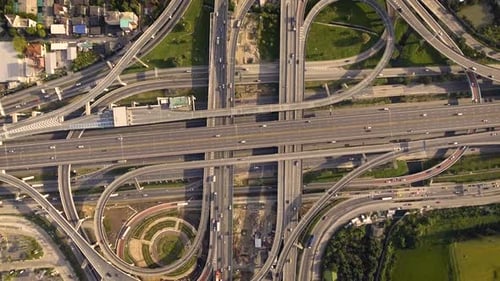 Aerial View of Highway Road Interchange with Busy Urban Traffic Speeding on Road