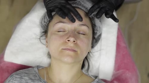Cosmetologist Applies Peeling Lotion on Woman Face in Beauty Clinic Salon