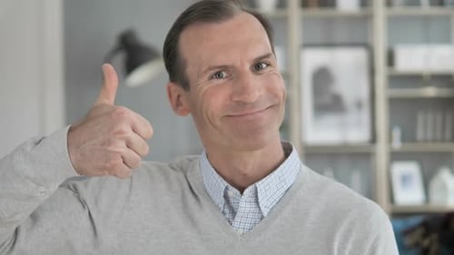 Smiling Man Gives Thumbs Up Sign