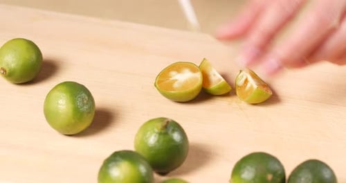Cutting Key Limes on a Wood Cutting Board
