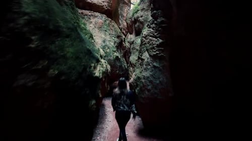 Cavern or cave exploration. Young exlorer walk through narrow paths in caves and caverns