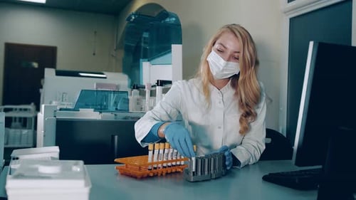 Lab Technician Handling Samples in Testing Facility