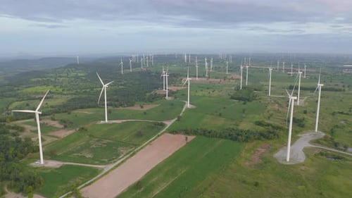 Aerial view of wind turbines or windmills farm field in industry factory. Power, sustainable green
