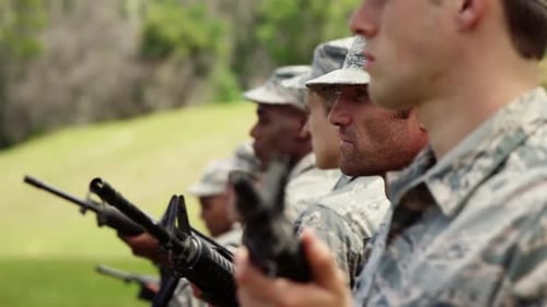 Soldiers in Camouflage Uniforms Holding Rifles Outdoors