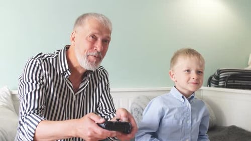 Man Playing Video Game With Child Indoors