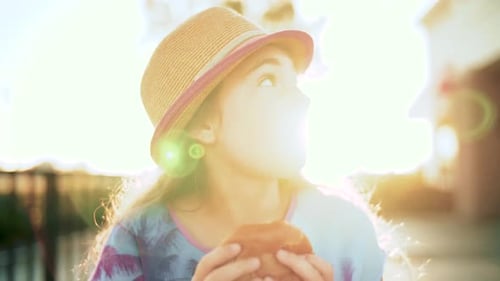 Child Enjoying Burger on Sunny Day