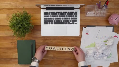 Term Coaching is Collected From Wooden Cubes with Letters on the Table View From Above