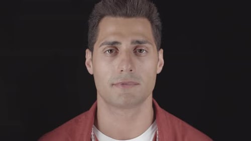 Man Opens Eyes and Smiles in Close Up