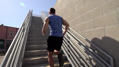 Man Running Up Concrete Outdoor Staircase During Daytime