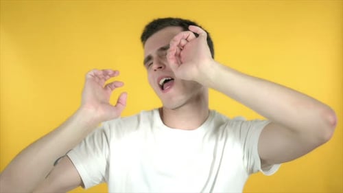 Young Man Dancing and Grooving to Music