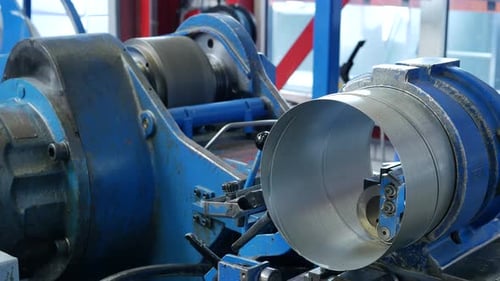 Machine forming metal cylinder