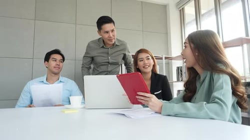 Team Discussing Ideas Around Conference Table