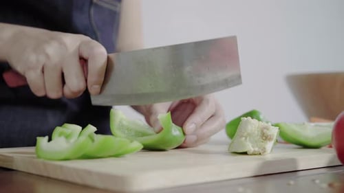 chief woman making salad healthy food and chopping bell pepper on cutting board.