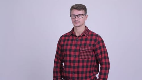 Man in Plaid Shirt Smiling Indoors