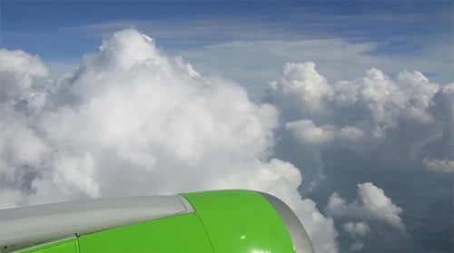 Clouds From Airplane Window on Sunny Day