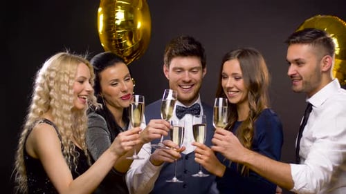 Friends Celebrate with Champagne and Golden Balloons