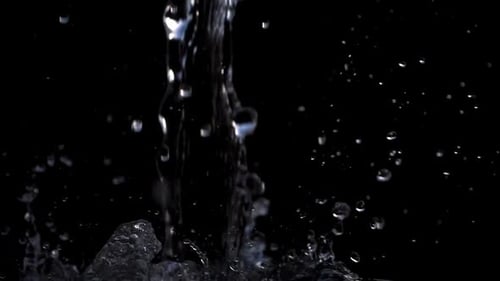 Water Pouring and Splashing on Black Background