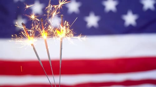 Sparklers burning in front of American Flag