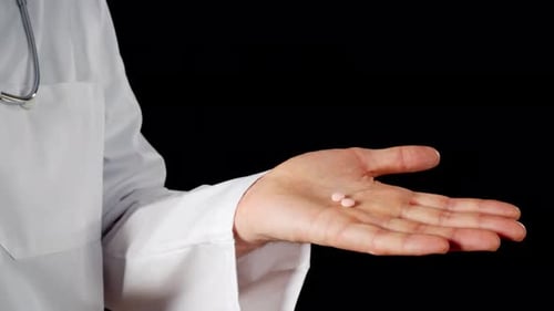 Pills in Hand of Adult Wearing Medical Coat