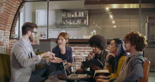 Colleagues and Clients Talking Strategy with Laptop and Tablet