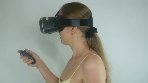 Woman Experiencing Virtual Reality with Headset and Controller