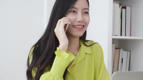 Young asian business woman working form home office and call phone for success at home.