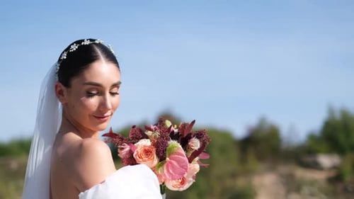 Smiling Woman Holding Bouquet in Sunlight