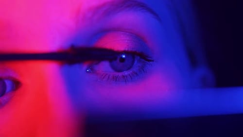 Close Up of Woman Applying Mascara in Studio