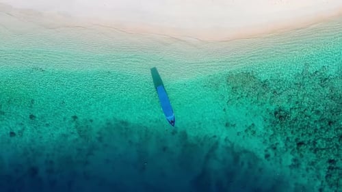 Coast and fishing boat as a background from top view. Turquoise water background from top drone.