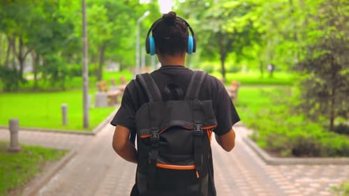 Guy Going and Dancing in City Park