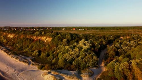 Landscape of the Little Village Situated on a Green Cliff Next to the Ocean Filmed By Drone