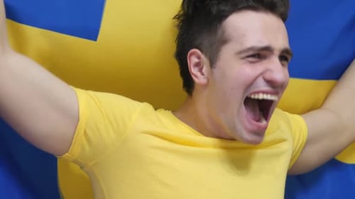 Enthusiastic Man Cheering with Arms Raised