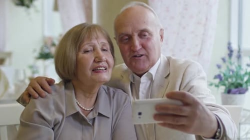 Elderly People Taking Selfie in Cafe