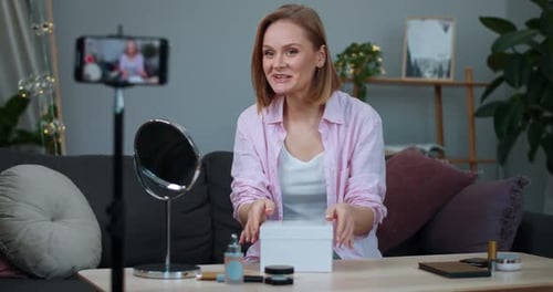 Young Woman Unboxing Beauty Products for Video Blog