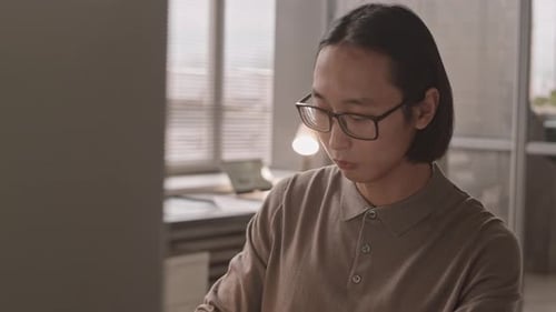 Young Adult Working in Modern Office Workplace