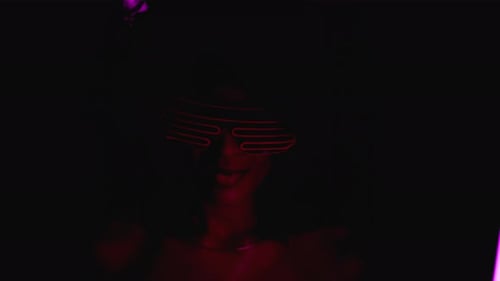Portrait of Glamorous African Woman on Party Under Glowing Colorful Light