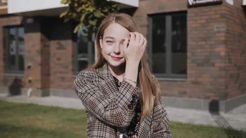 Stylish Young Woman Posing in Front of Building