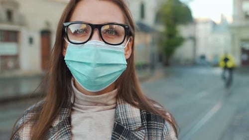 Woman Wearing Face Mask and Glasses on Street