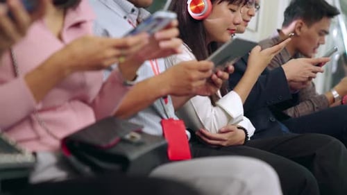 Commuters Using Technology on Public Transportation