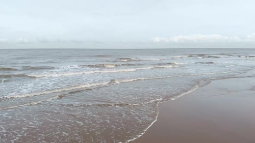 Foamy Waves Rolling On The Shore At The North Sea Beach In South Holland, Netherlands. Aerial Drone