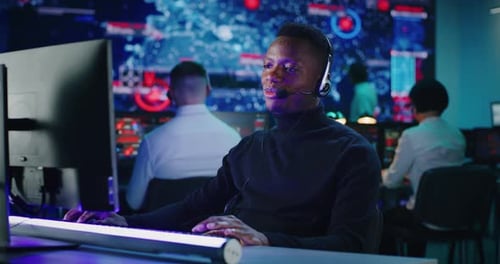 Cheerful African American Man Working in High Tech Security Center