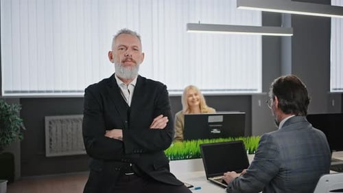 Confident Businessman Smiling in Modern Office Environment