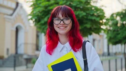 Portrait of Teenage Female Student with Books Backpack Outdoors on City Street