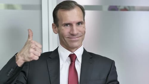 Adult Man Giving Thumbs Up in Office
