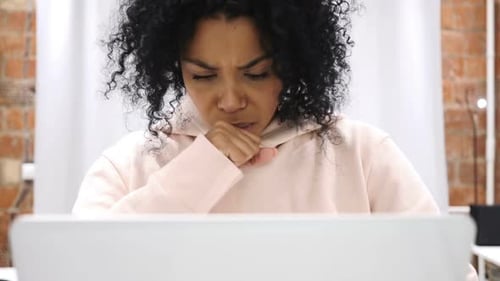 Woman Coughing While Working on Laptop