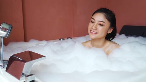 Woman Relaxing in Luxurious Bubble Bath at Home