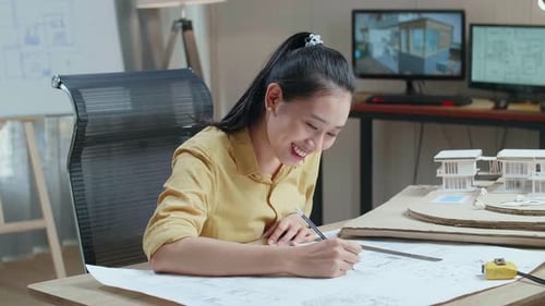 Ingeniero mujer asiática con un portátil dibujo plano en la oficina