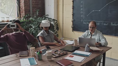 Colleagues Testing VR Goggles in Office
