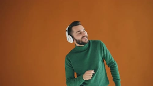 Man Dancing and Listening to Music with Headphones